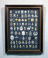 Объемная работа «Значки» 63,7х48,2
(рамка деревянная, короб, стекло стандартное, оргалит, установка работы в раму, паспарту, обклейка стенок короба)
